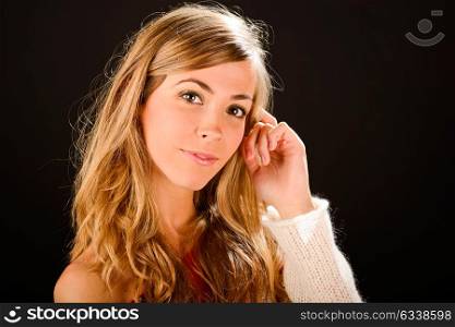 Young blonde woman studio portrait on black background
