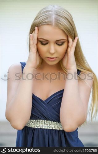Young blonde woman suffering of the pain, indoor