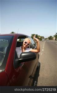 young blonde woman with keys in the car