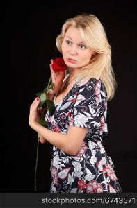Young blonde woman with red rose.