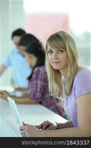 Young blonde woman working in an office