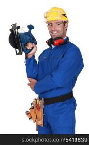 young blue collar with protective equipment and sander machine