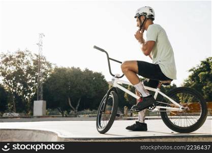 young bmx rider looking away low angle shot