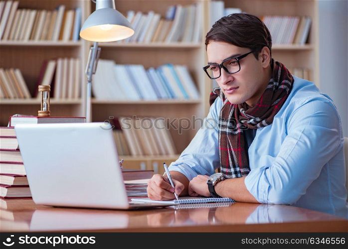Young book writer writing in library