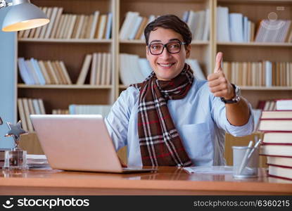 Young book writer writing in library