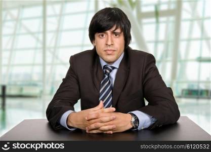 young bored businessman on a desk at the office