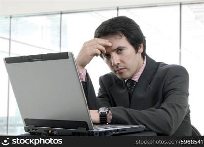 young bored man and working with is laptop