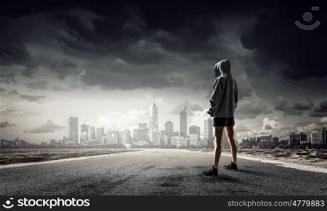 Young boxer woman outdoor. Young boxer woman standing outdoors against city landscape