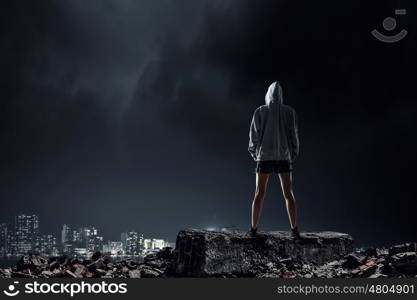 Young boxer woman outdoor. Young boxer woman standing outdoors against city landscape