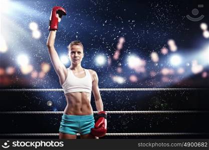 Young boxer woman. Young pretty boxer woman standing on ring under water drops