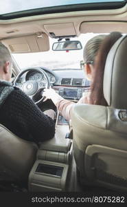 Young boy and girl driving a car. Car interior