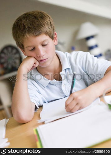 Young Boy Doing Homework In His Room