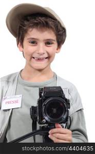 Young boy dressed as a press photographer