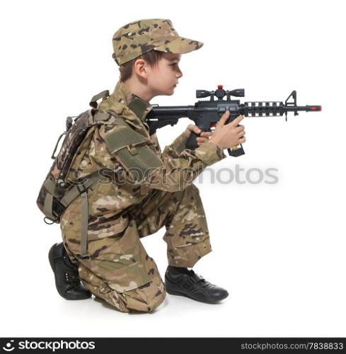 Young boy dressed like a soldier with rifle isolated on white