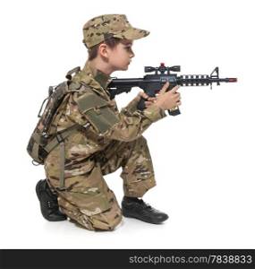 Young boy dressed like a soldier with rifle isolated on white