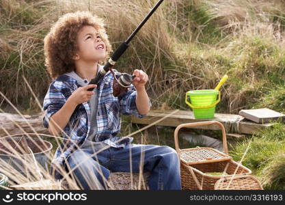 Young Boy Fishing At Seaside