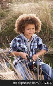 Young Boy Fishing At Seaside
