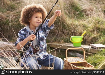 Young Boy Fishing At Seaside