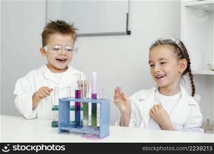 young boy girl scientists having fun doing experiments laboratory