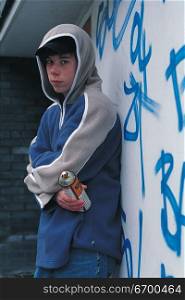 young boy holding a spray paint can