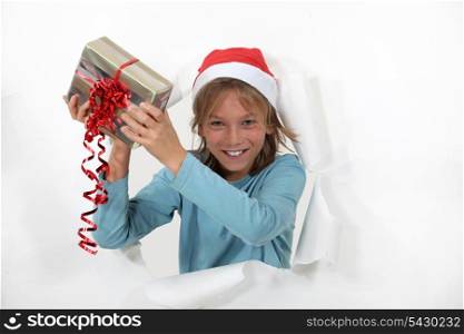 Young boy holding his Christmas present.
