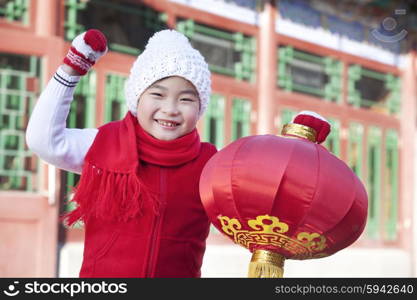 Young boy holding red lantern