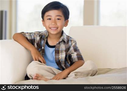 Young boy in living room smiling