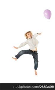 Young Boy Jumping With Balloon In Studio