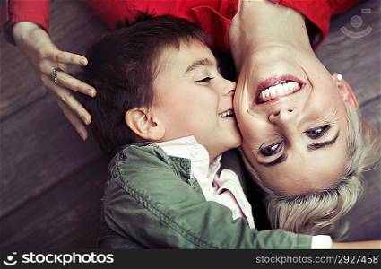 Young boy kissing his smiling mom