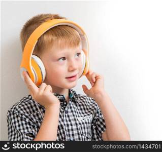 young boy listen music with headphone