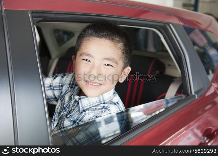 Young Boy Looking Out a Car Window