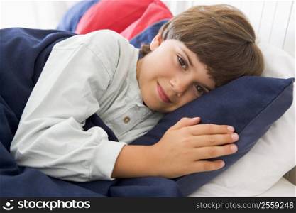 Young Boy Lying Down In His Bed
