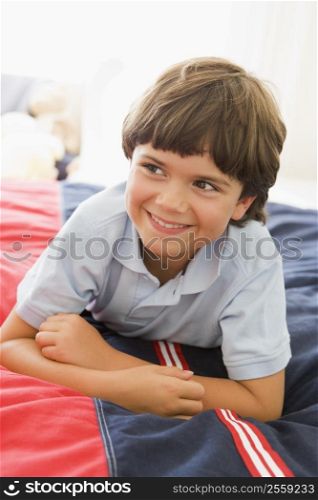 Young Boy Lying Down On His Bed