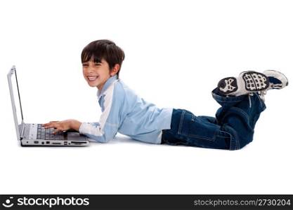 Young boy lying on floor and surfing on his laptop