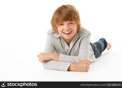 Young Boy Lying On Stomach In Studio