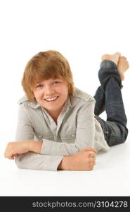 Young Boy Lying On Stomach In Studio