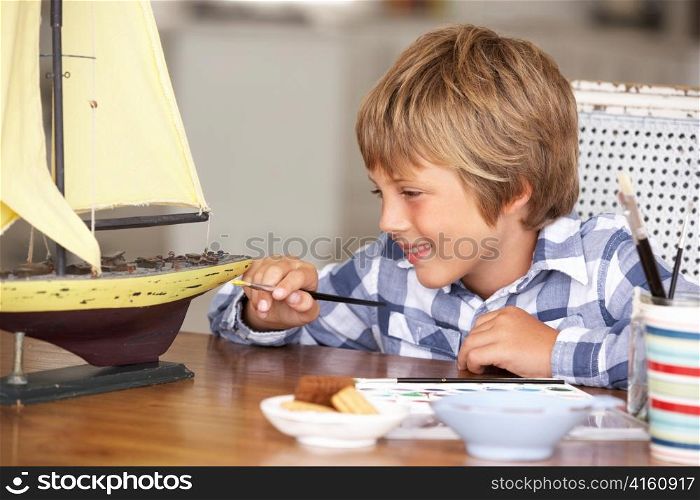 Young boy making model ship