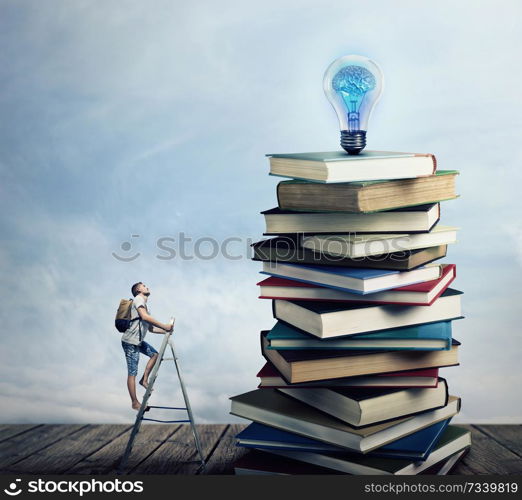 Young boy on the ladder, with a bag on his back, trying to climb a pile of books looking for a lightbulb. In search of knowlegde concept.