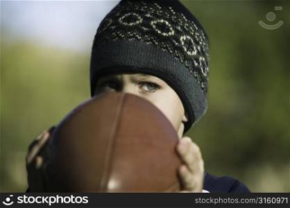 Young boy playing football