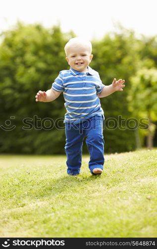 Young Boy Playing In Summer Garden