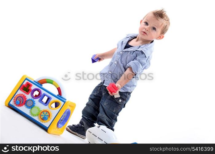 Young boy playing with a shape sorting toy