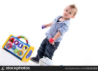 Young boy playing with a shape sorting toy