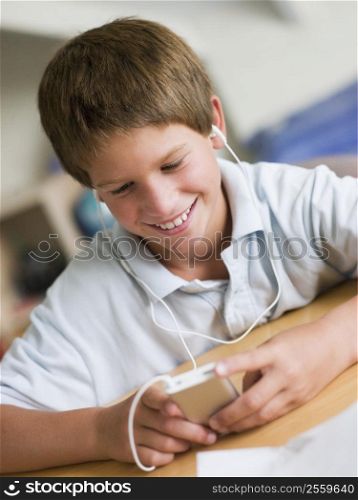 Young Boy Playing With An MP3 Player