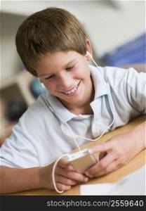 Young Boy Playing With An MP3 Player