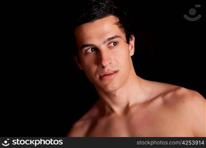 Young boy posing isolated over black background