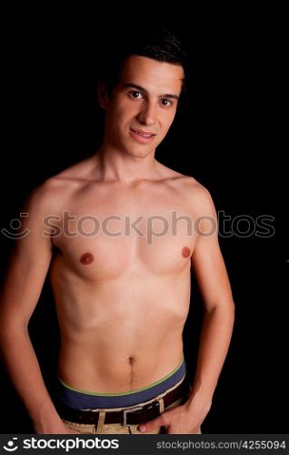 Young boy posing isolated over black background