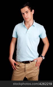 Young boy posing isolated over black background