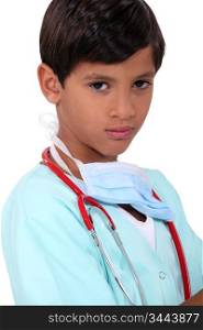 Young boy pretending to be a doctor
