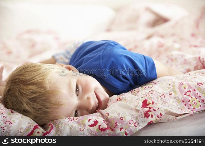Young Boy Relaxing On Bed