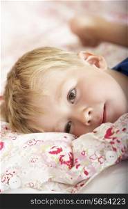 Young Boy Relaxing On Bed